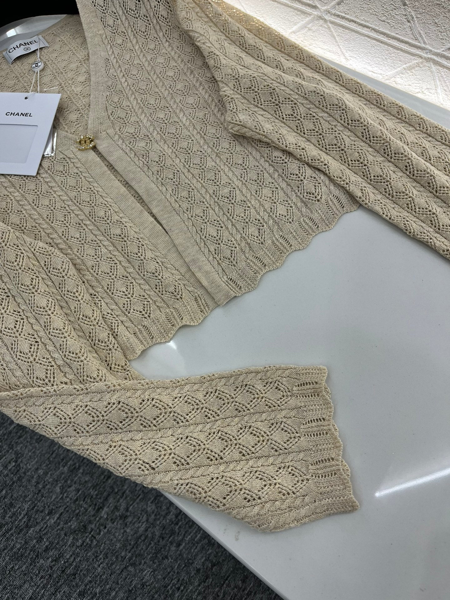 Single-button hollow knitted cardigan